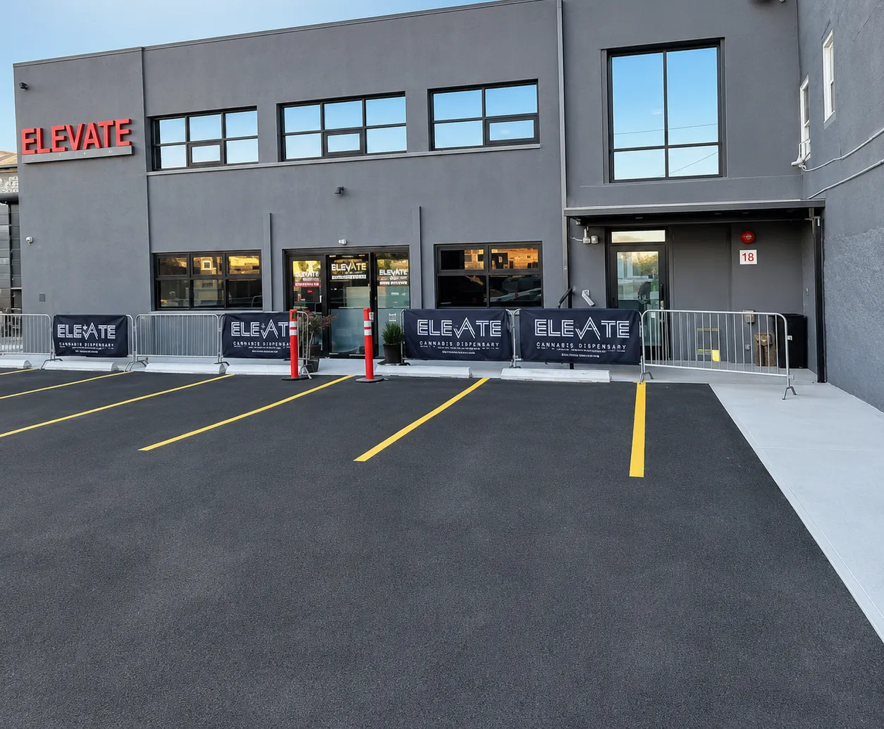 Elevate Cannabis storefront with red channel-letter sign and the parking lot out front