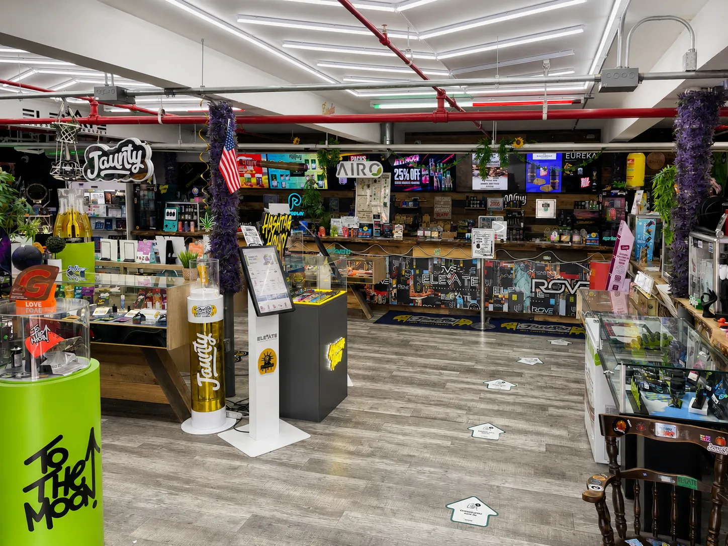 Elevate Cannabis sales floor with glass display cases, ordering kiosks and a stocked product wall