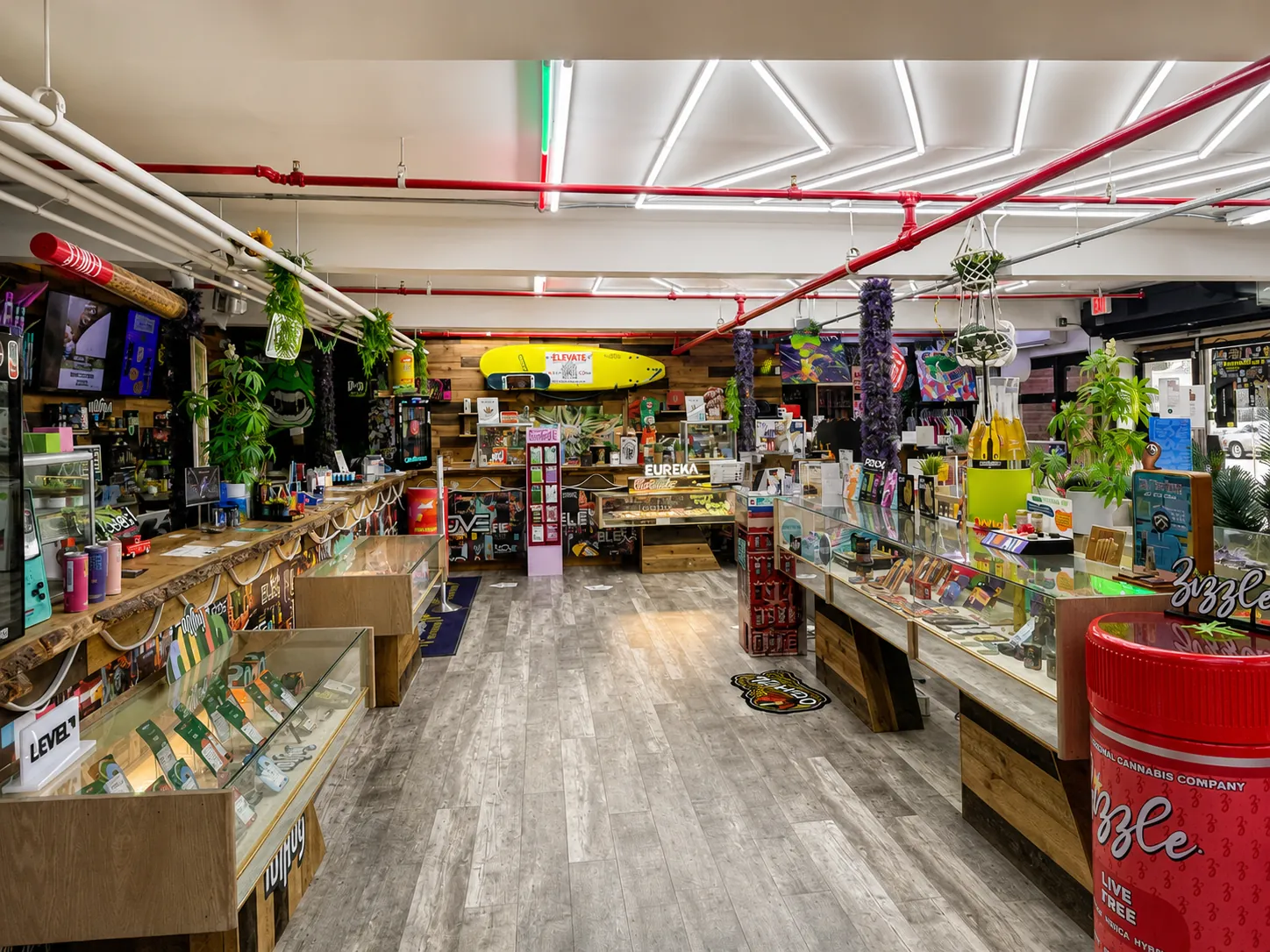 Walkway through the Elevate store past display counters toward the front windows